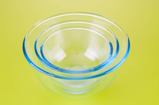 istock Empty glass food bowls on a green background 1391082496