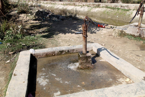 Traditional and old hand pump to pull underground water in India by moving the lever up and down.