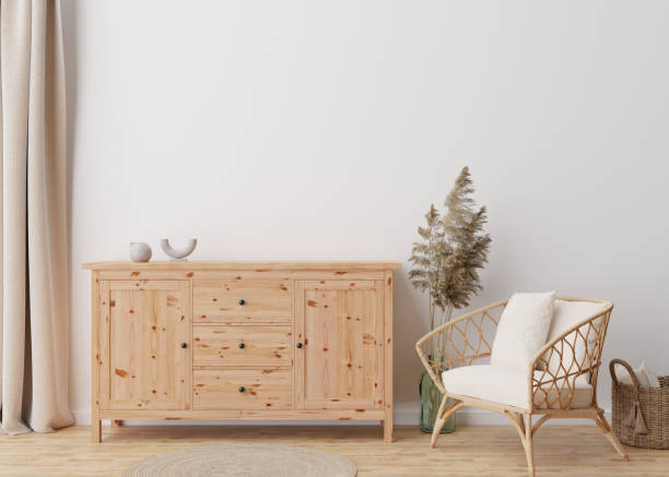 istock Empty white wall in modern living room. Mock up interior in scandinavian, boho style. Free, copy space for your picture, text, or another design. Sideboard, rattan armchair, pampas grass. 3D rendering 1391084283