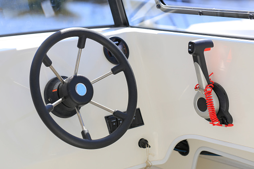 Cockpit modern motor boat with steering wheel and throttle control