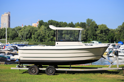 New motor boat on a trailer on the shore