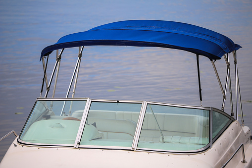 Open cockpit of a motorboat with an awning close-up