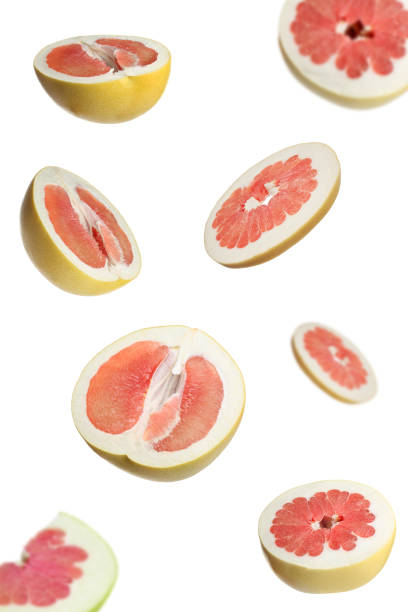 istock Fresh exotic pomelo fruits falling on white background 1391086804
