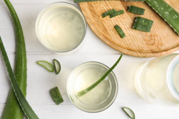 istock Flat lay composition with fresh aloe drink and leaves on white wooden table 1391087015