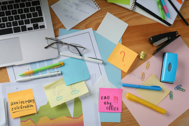 istock Messy table with laptop and sticky notes, flat lay. Concept of being overwhelmed by work 1391087814