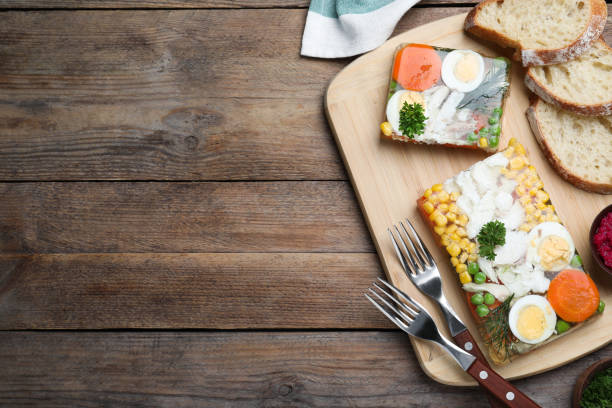 Delicious fish aspic served on wooden table, flat lay. Space for text Delicious fish aspic served on wooden table, flat lay. Space for text aspic stock pictures, royalty-free photos & images