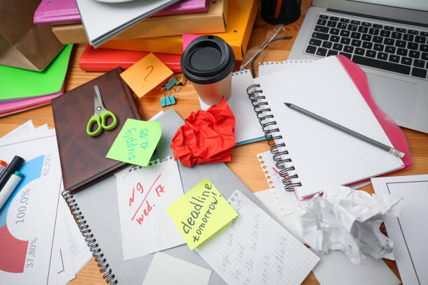 istock Messy table with laptop and sticky notes, above view. Concept of being overwhelmed by work 1391088286