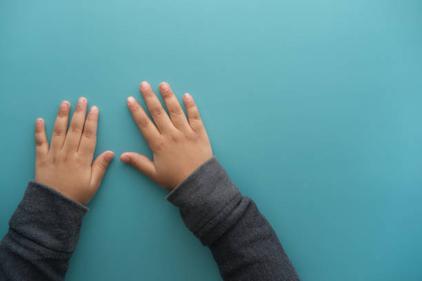 istock Child hand on green background with copy space 1391088306