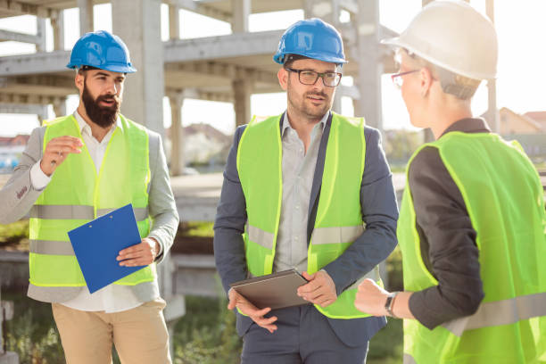 istock Group of architects meeting on a construction site 1391088382