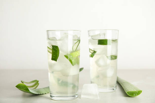 istock Fresh aloe drink in glasses and leaves on light table 1391089002