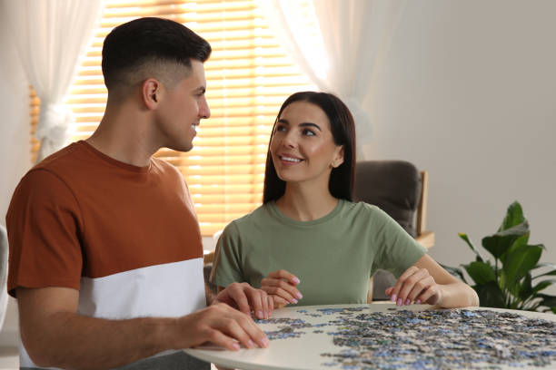 istock Happy couple playing with puzzles at home 1391089130