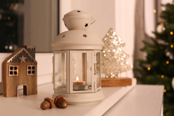 istock Decorative Christmas lantern with burning candle on windowsill 1391089312