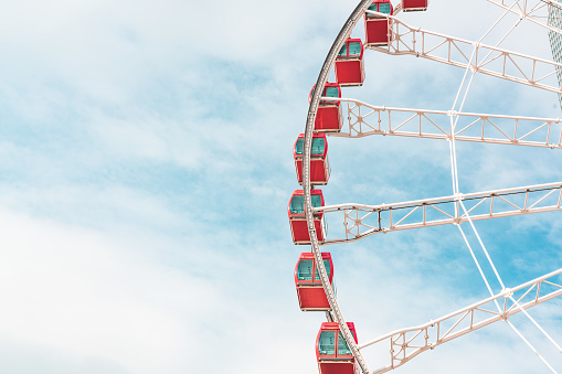 Ferris wheel in the blue sky and white clouds background
