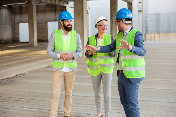 istock Team of young architects inspecting works on a construction site. Wide angle view. 1391089543
