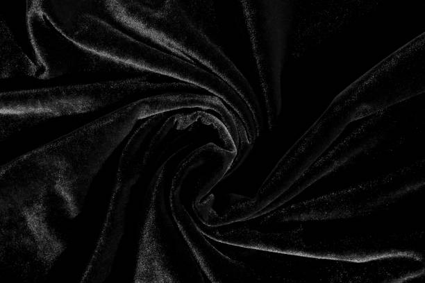 istock Black velvet spun fabric in the middle. Abstract texture. 1391089740