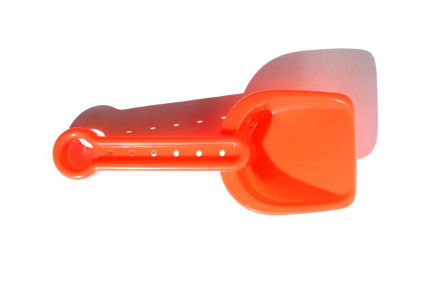 istock A red toy shovel lies on a white background. 1391089897