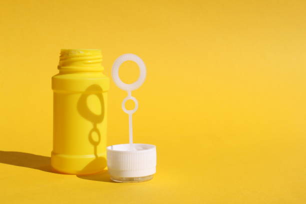 istock Children's entertainment game soap bubbles on a yellow background. 1391090432