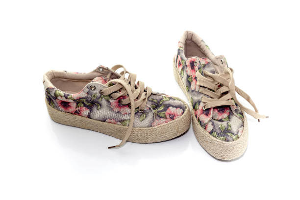 Female athletic shoes with a floral pattern on a white background close-up