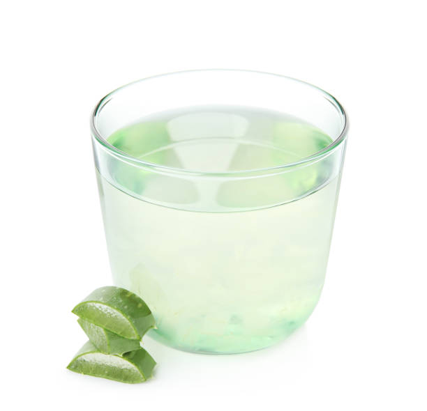 Fresh aloe drink in glass and leaf slices on white background Fresh aloe drink in glass and leaf slices on white background aloe juice stock pictures, royalty-free photos & images