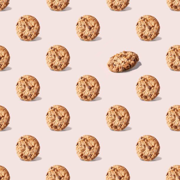 istock oatmeal cookies with chocolate on a beige background, seamless pattern 1391095602