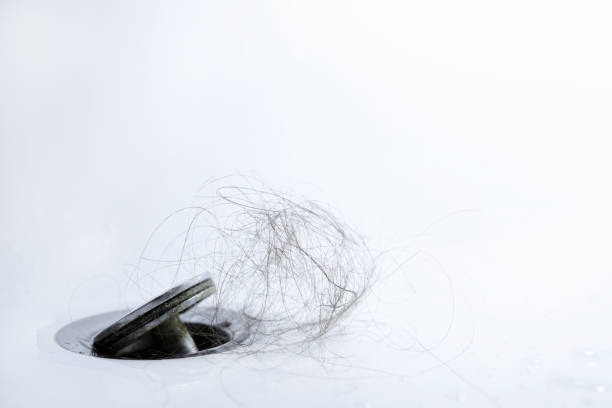 istock Water drain is clogged with hair. 1391096617