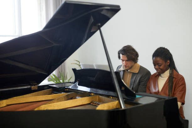 istock Young couple playing the piano together 1391097914