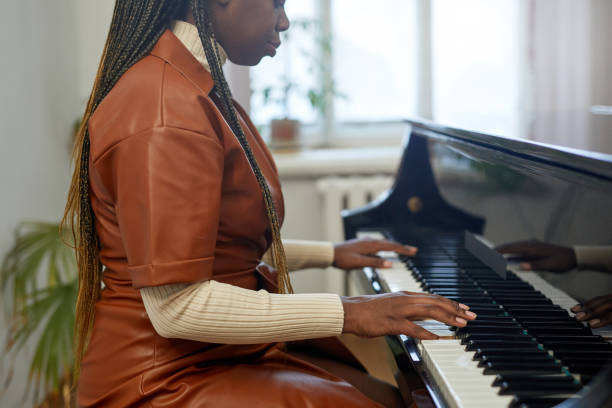 istock Woman learning to play the piano 1391097964