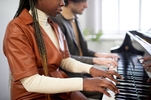 istock Woman playing the piano together with partner 1391098657