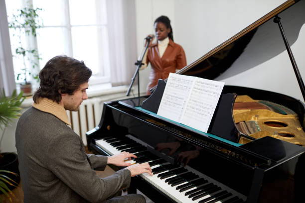 istock Pianist playing the piano in the classroom 1391098670