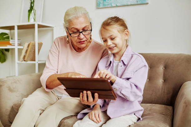 istock Little Girl using Tablet with Grandma 1391098911