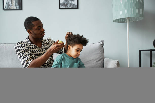 Father Taking Care of Curly Black Hair