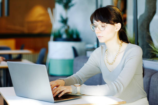 istock Woman using Laptop in Mall lit by Sunlight 1391101076