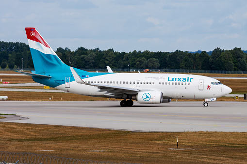 Munich, Germany - July 28, 2015: Luxair passenger plane at airport. Schedule flight travel. Aviation and aircraft. Air transport. Global international transportation. Fly and flying.