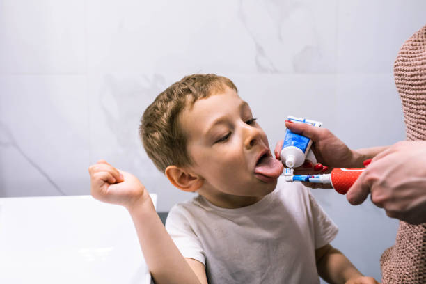 istock A funny boy sticking his tongue out to taste toothpaste 1391103547