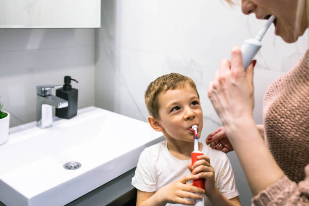 istock A boy having fun brushing his teeth with his mom 1391103557