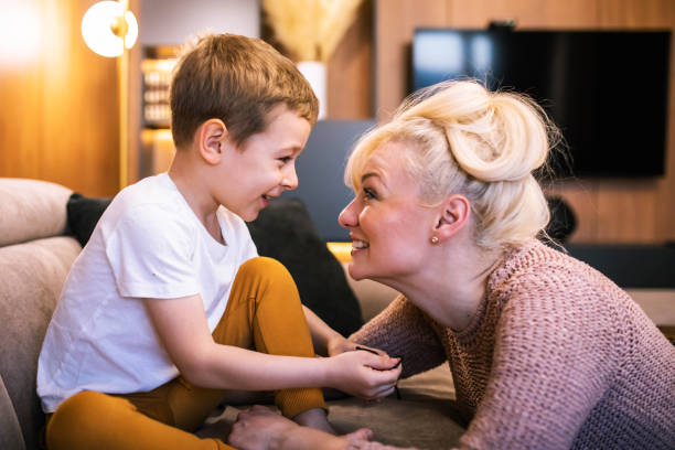 istock A cute boy having fun at home with his mom 1391103577