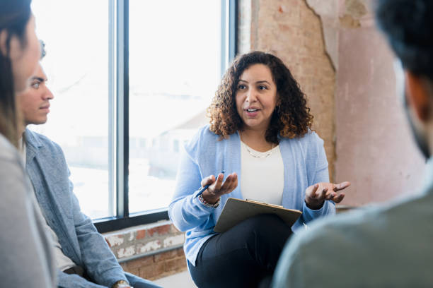 istock Female manager spreads hands while asking question in staff meeting 1391105389