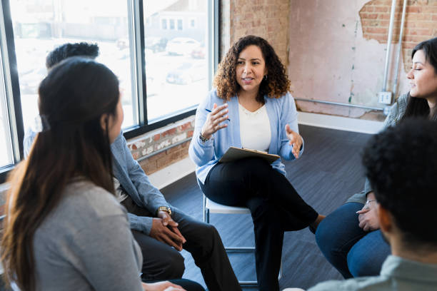 istock Diverse employees sit in circle and listen to manager 1391105416
