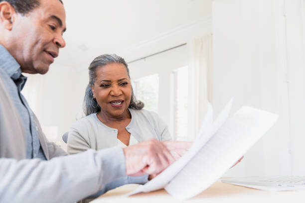 istock Husband helps explain paperwork to wife 1391105908