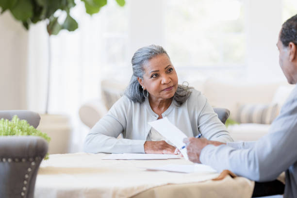 istock Senior couple reviews retirement paperwork 1391107083