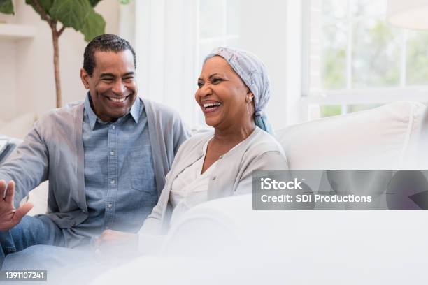 Senior couple smiles and laughs at joke