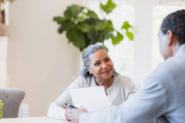 Senior widow listens to unrecognizable male financial advisor