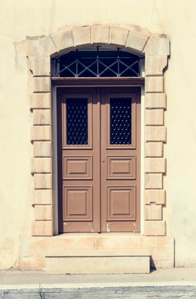 istock The background old beige stony wall with retro door 1391108539
