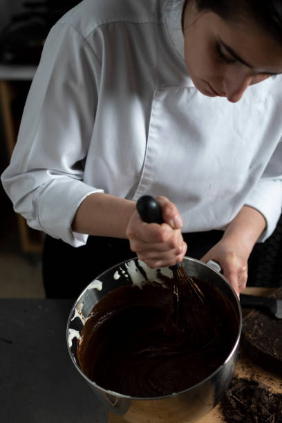 istock Female confectioner preparing chocolate sauce 1391109985