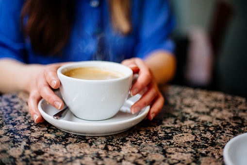 Woman holding coffee cup close-up