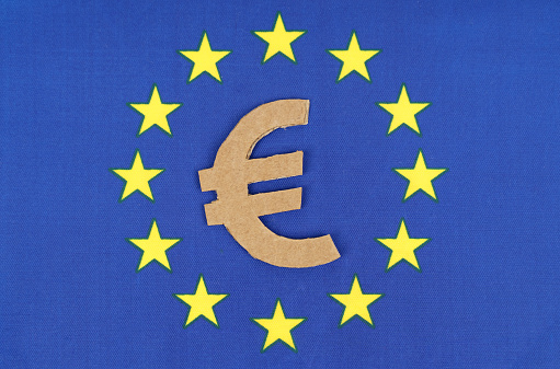 Economy and finance concept. The euro symbol on the flag of the European Union.