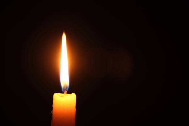 istock Flame burning candle black background.Concept memory and sorrow. 1391113941