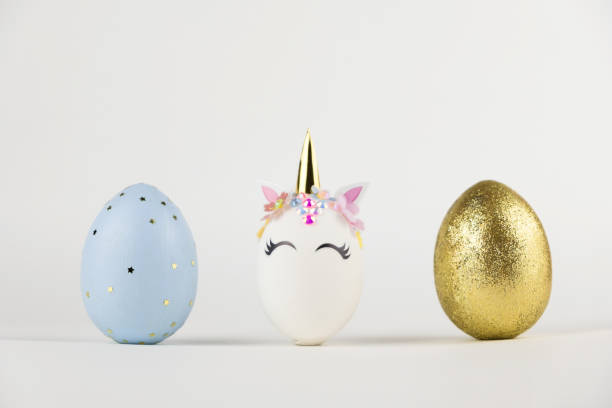 istock Easter eggs isolated on white background. Happy easter banner. Kids activity inspiration. Greeting card or poster with unicorn egg. Decoration golden, pink. blue eggs 1391114750