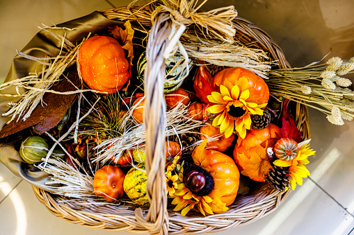 Happy Thanksgiving day. Composition with pumpkins, corn cobs and berries on wooden table, closeup