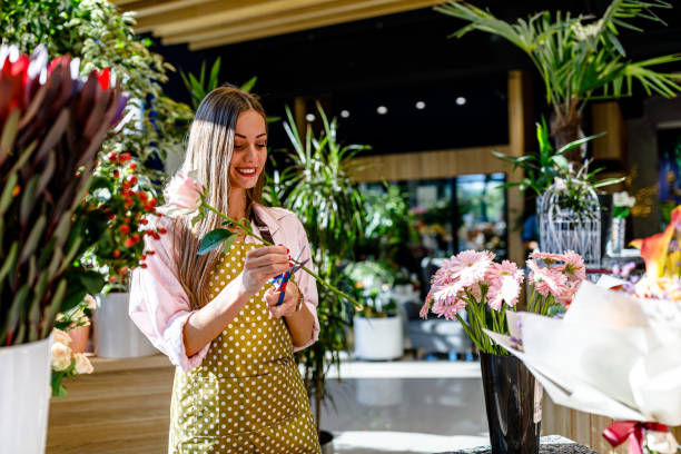 istock A female florist in a modern flower store is using scissors. 1391115051